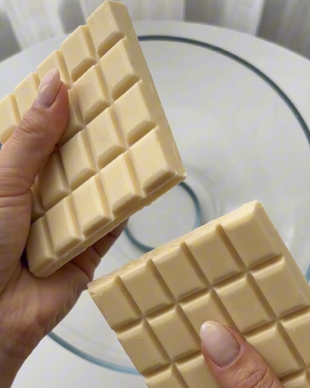 Valkosuklaan sulatus kulhossa Ube Nolia ube-pistaasikinuskipalloja varten
